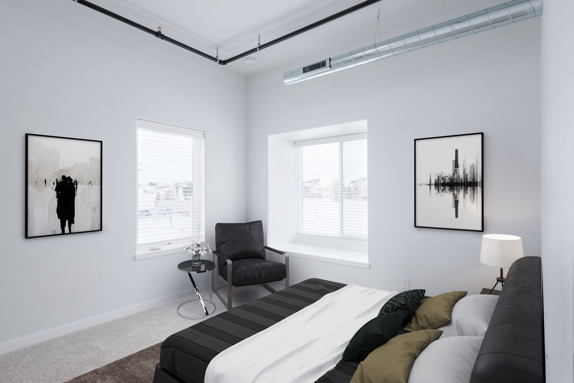 Minimalist gray bedroom with bed, chair, lamp, and abstract wall art by bright windows