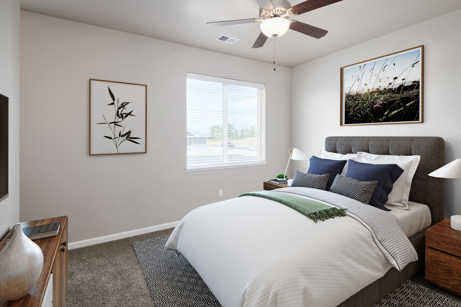 Bright bedroom with white bedding, gray rug, framed art, and a window with blinds