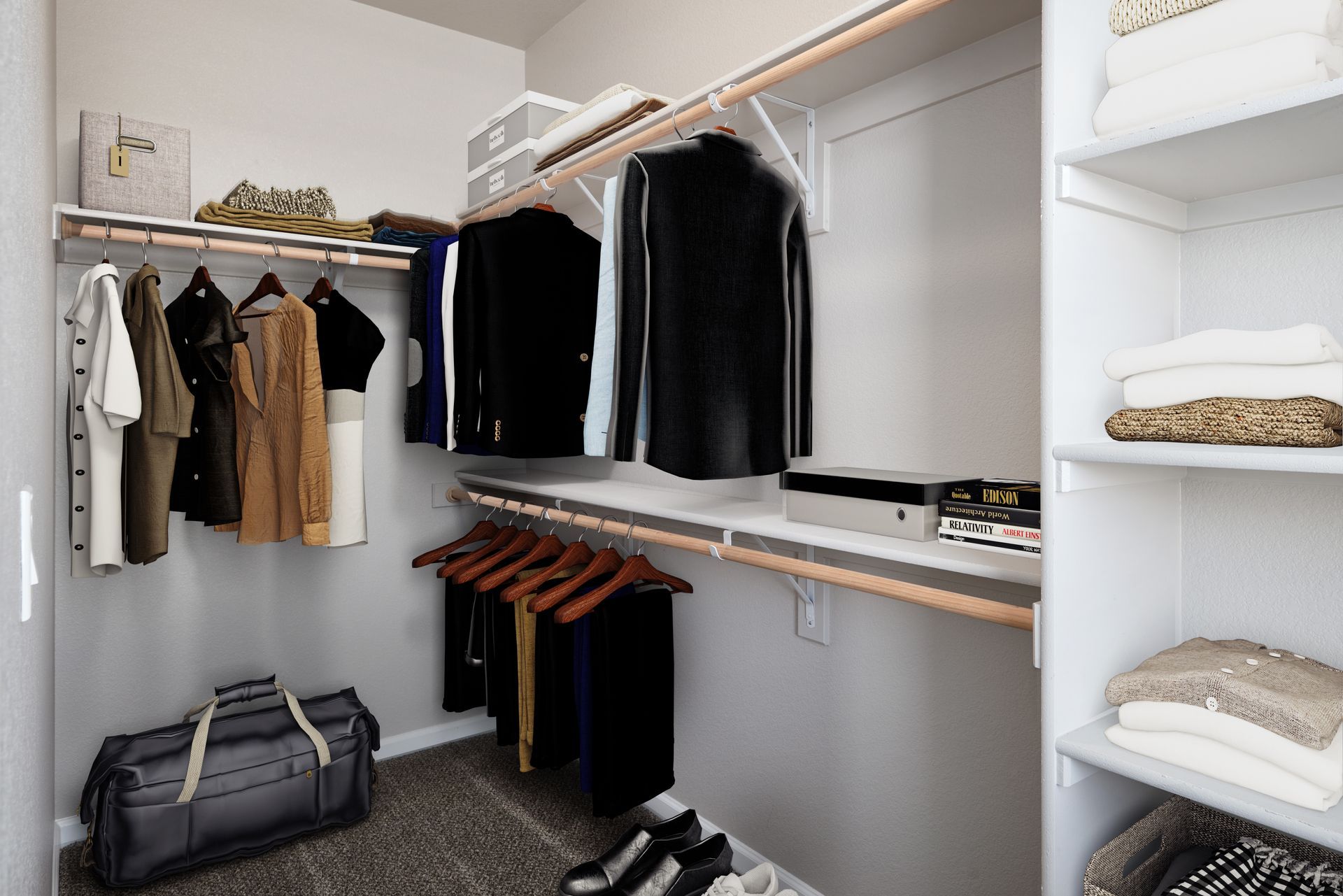 Walk-in closet with hanging clothes, shelves of folded linens, and a duffel bag on the floor