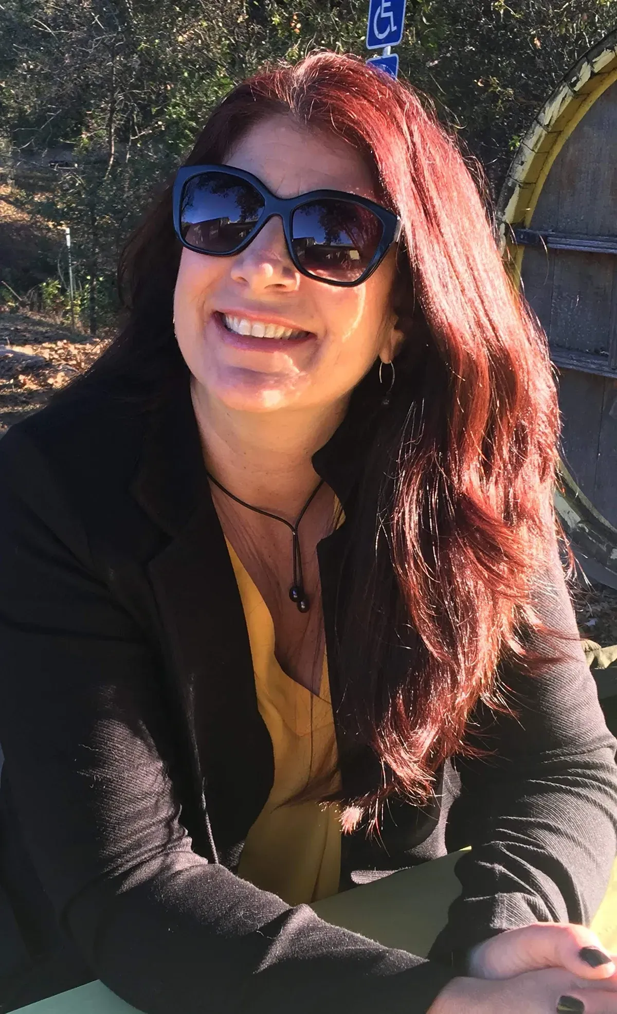 A portrait photo of Paula at a winery