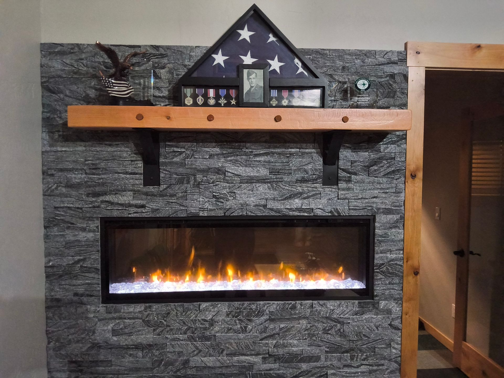 A fireplace with an american flag on top of it