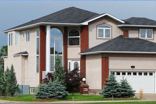 A large house with a black roof and a lot of windows