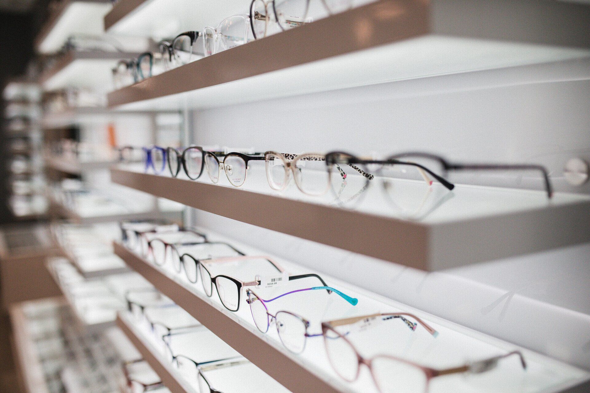 young woman trying on eyeglasses at Eye Associates of North Jersey
