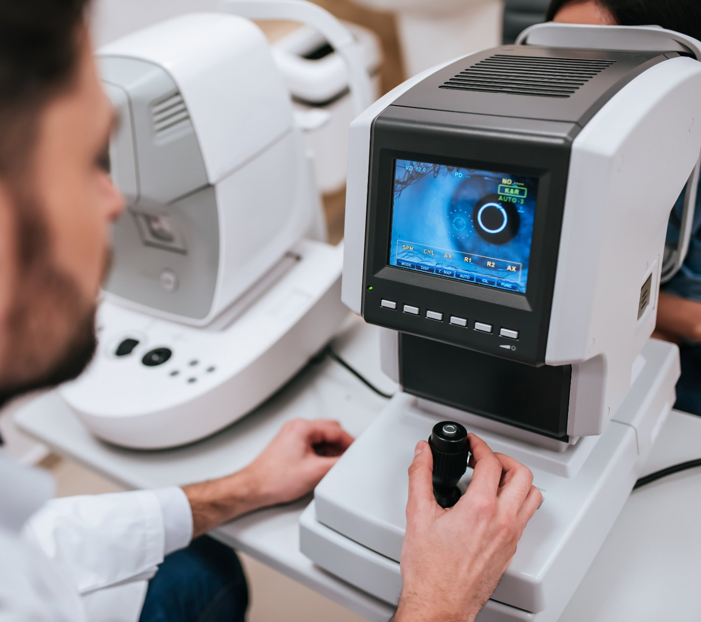 optometrist using special equipment for eye tests