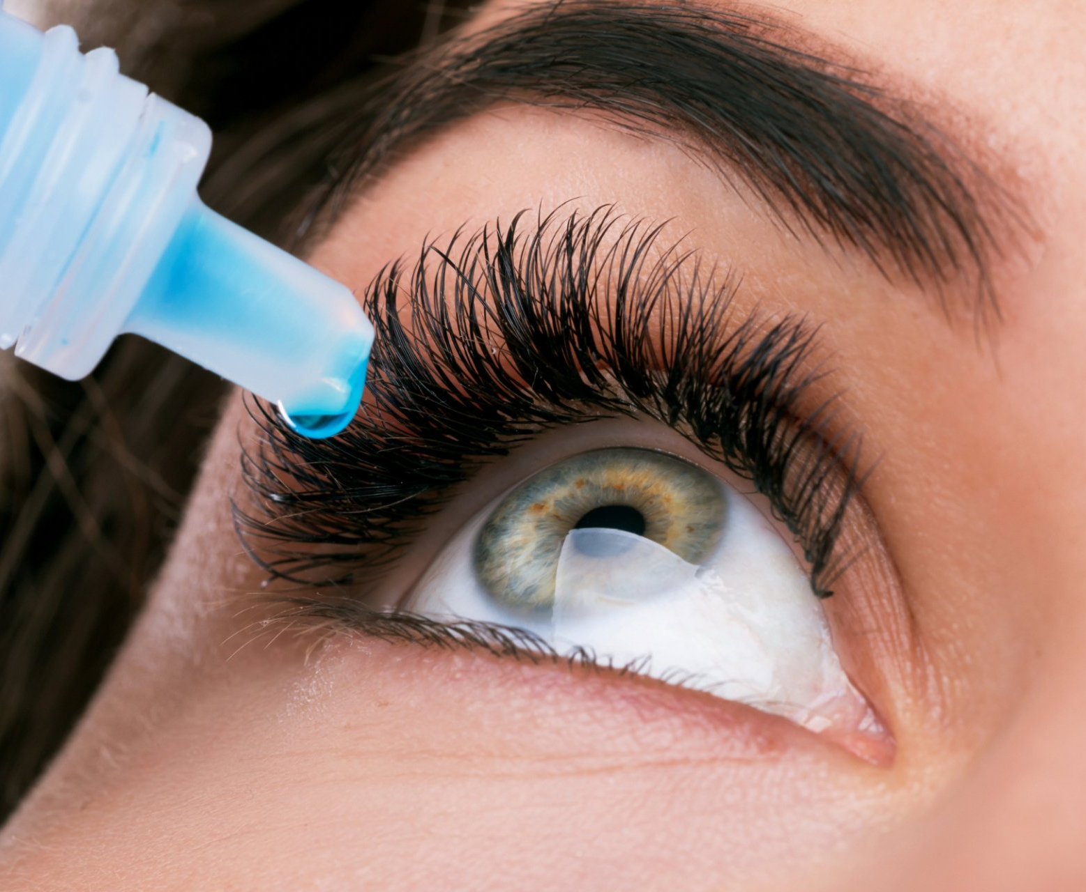 woman using eye drops for dry eye condition