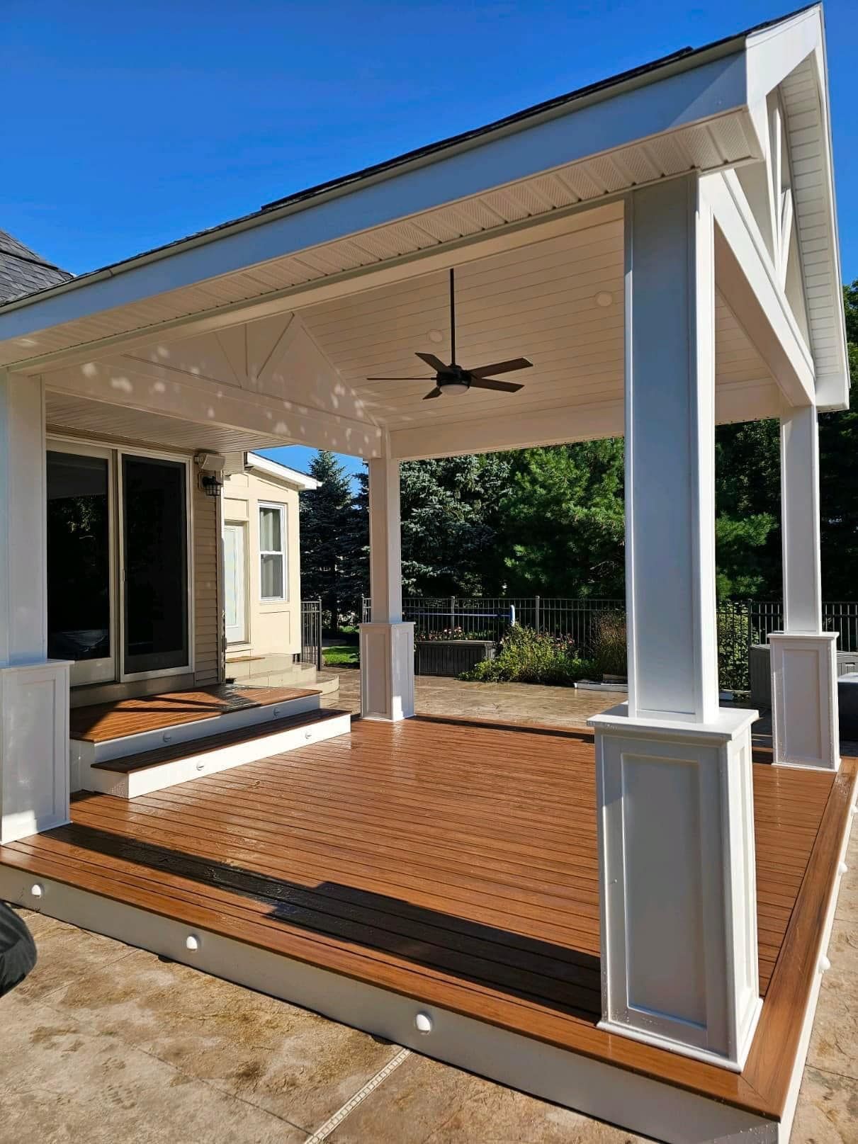 There is a ceiling fan on the roof of the porch.