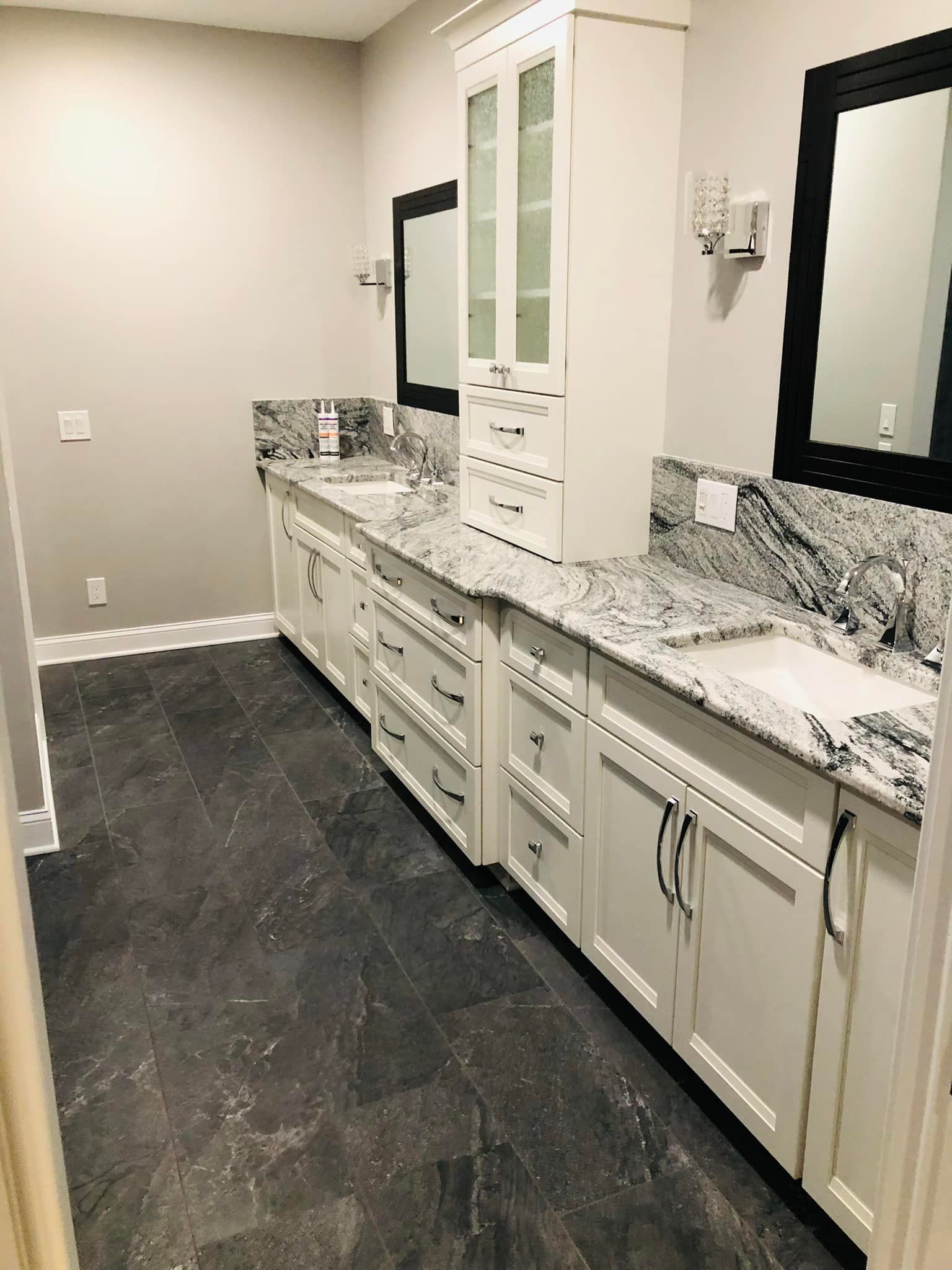 A bathroom with two sinks and two mirrors.