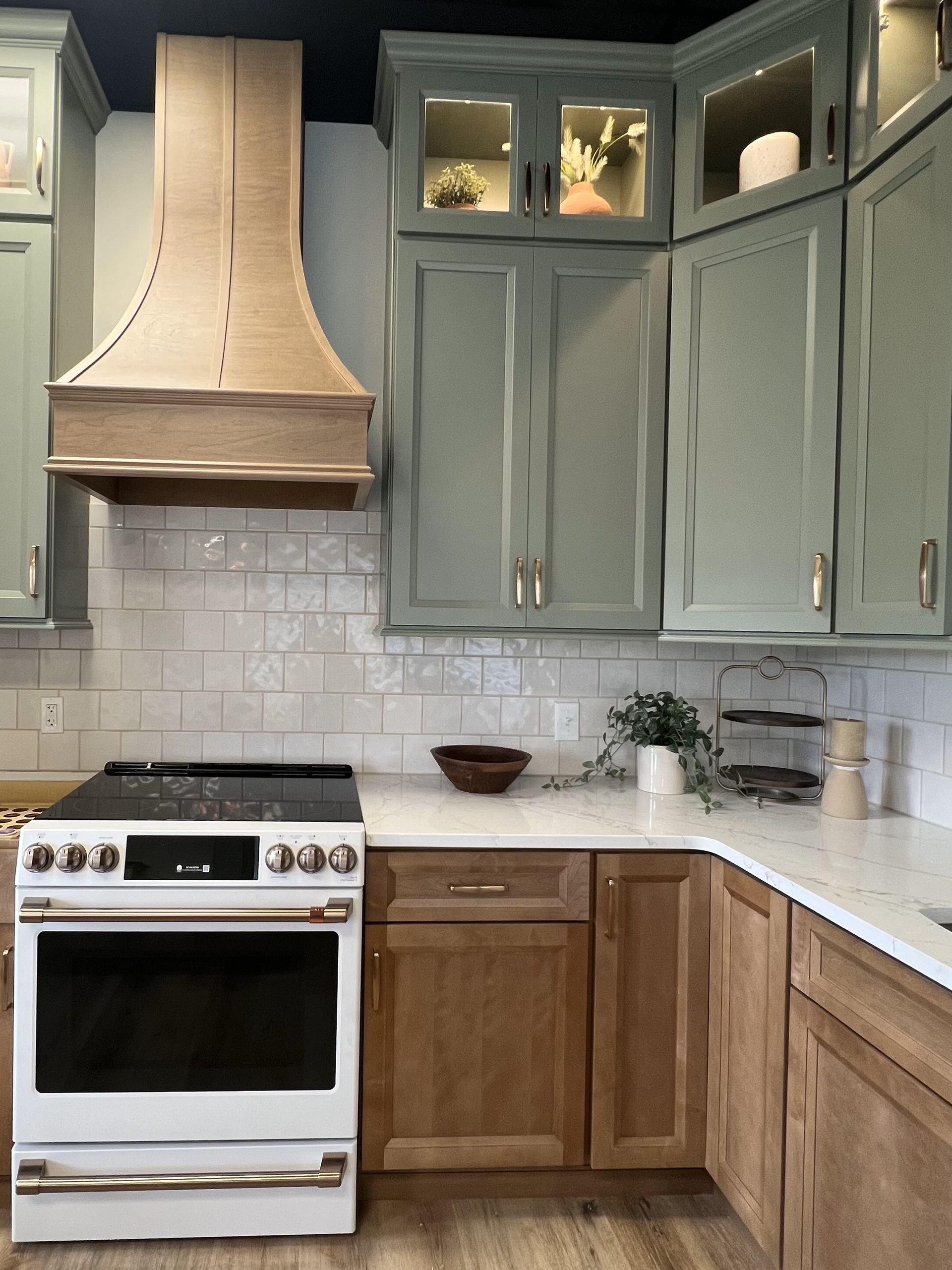 A kitchen with wooden cabinets and a white stove