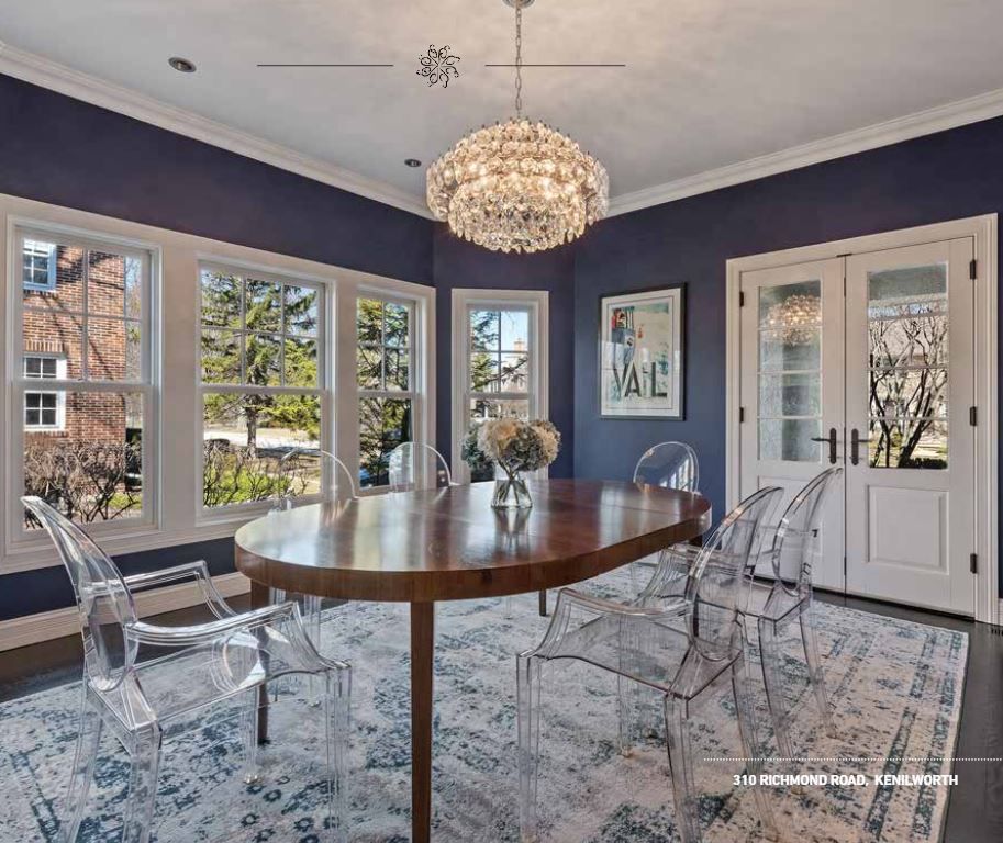 A modern kitchen with white shaker cabinets, stainless steel appliances, a center island, and hardwood floors.