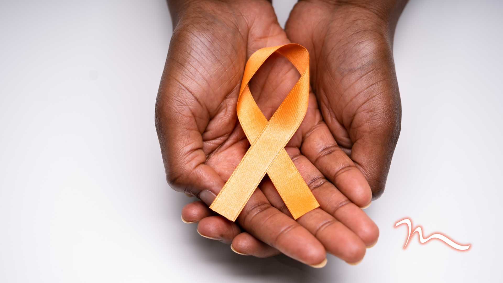 Hands holding an orange awareness ribbon on a white background