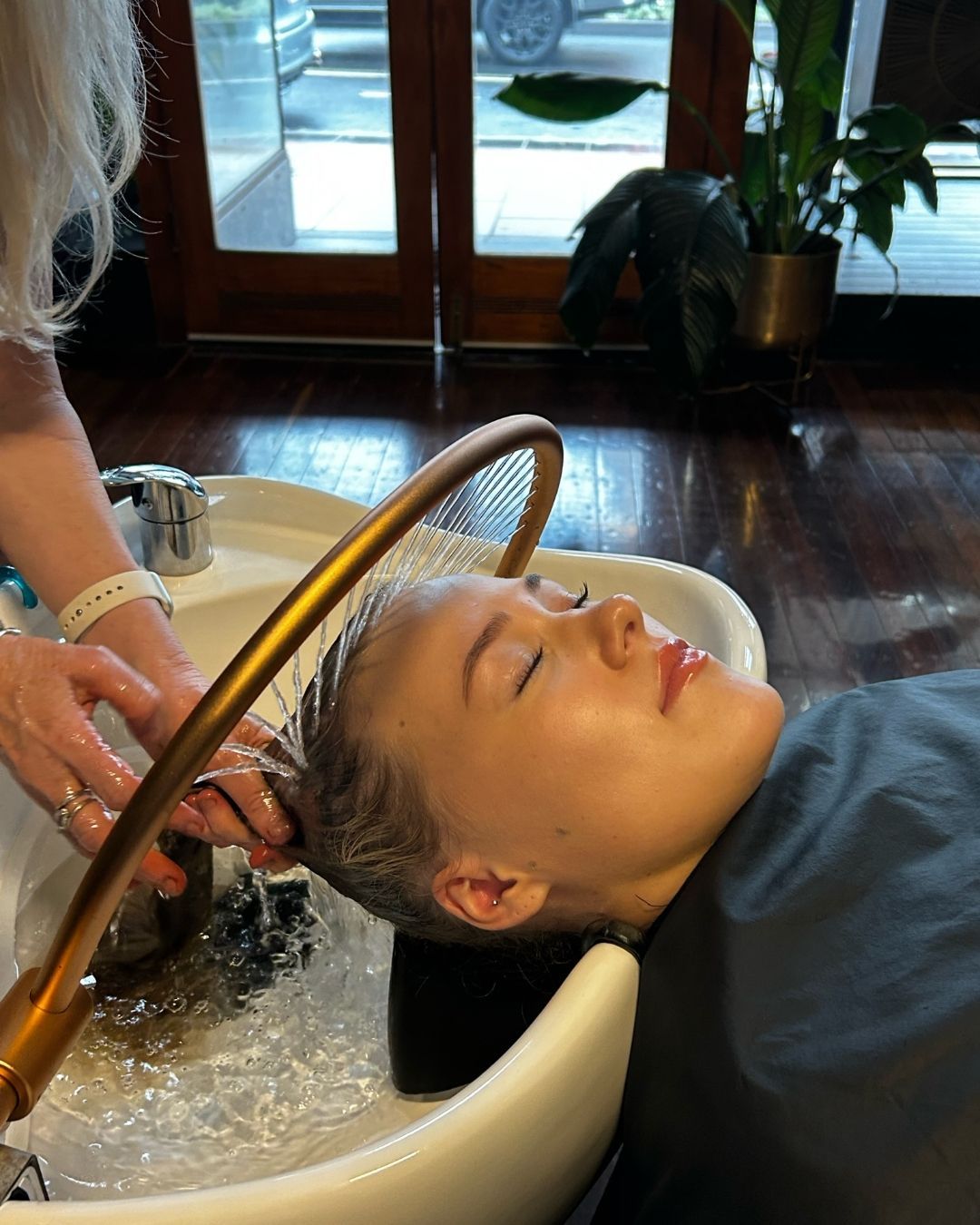 Person Receiving a Hair Wash at a Salon Sink — Air Hair Studio in Toowoomba City, QLD