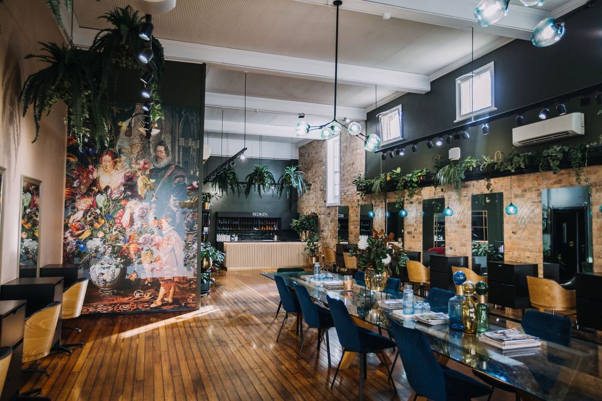 Hair Salon Interior with Long Table, Chairs, Mirrors, and Floral Mural — Air Hair Studio in Toowoomba City, QLD