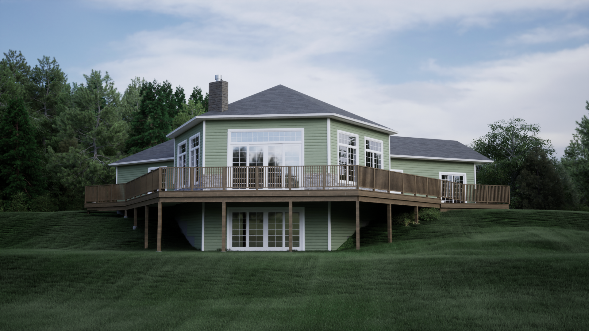 A green house with a large deck is sitting on top of a grassy hill.