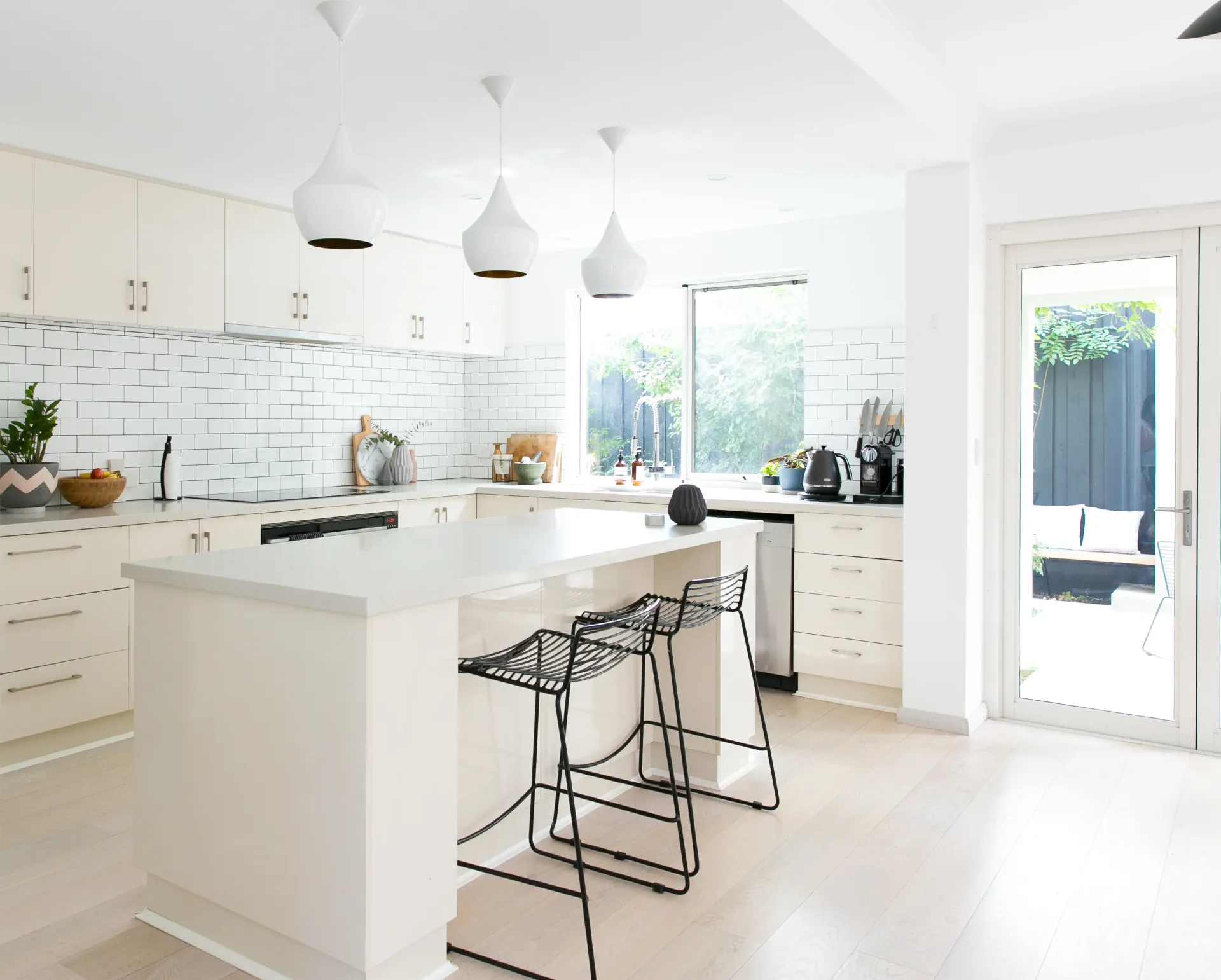 grey kitchen interior with gas stove and plant on the table
