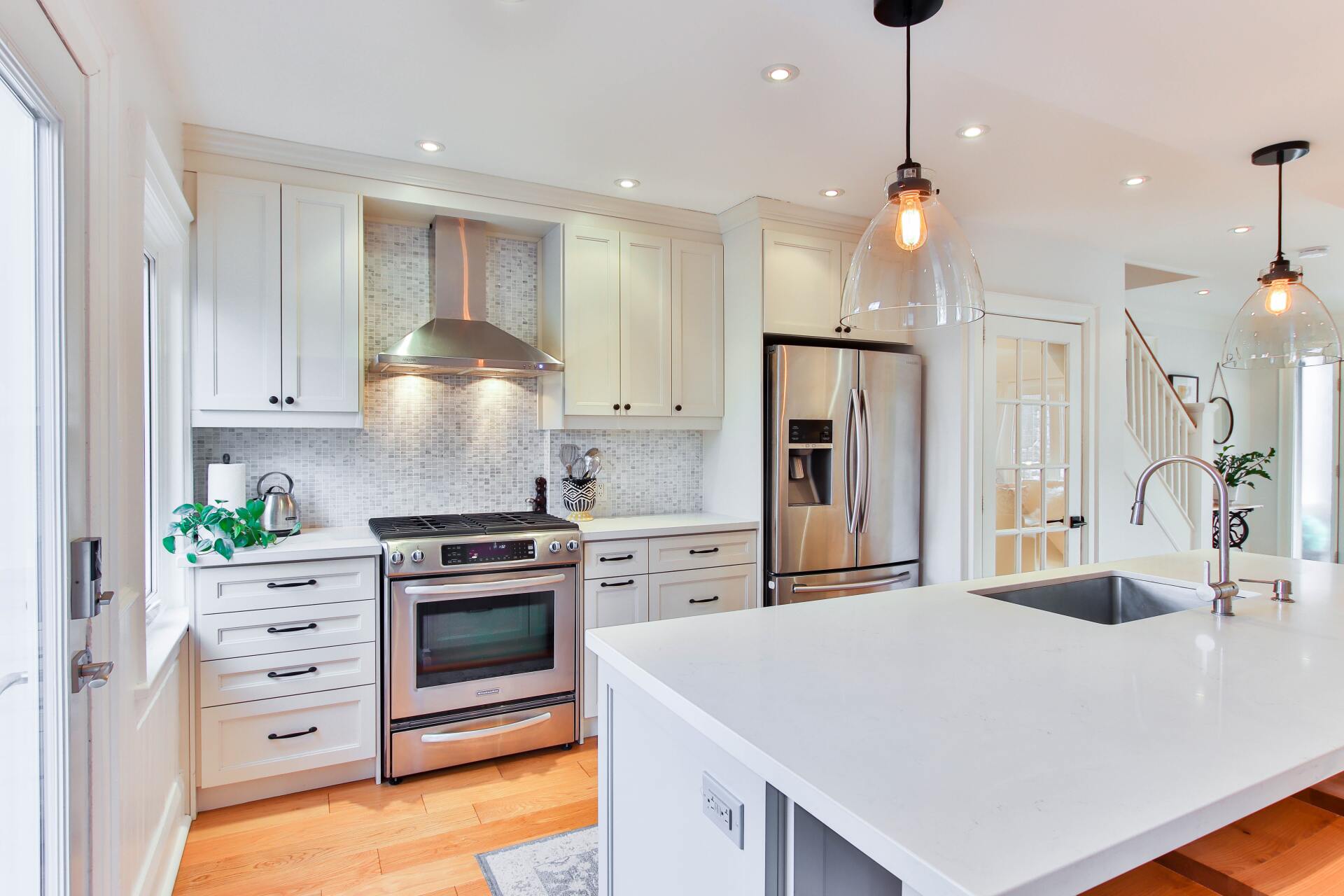 white kitchen interior with hanging lights