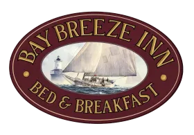 Bay Breeze Inn Bed & Breakfast oval logo with sailboat illustration on maroon background