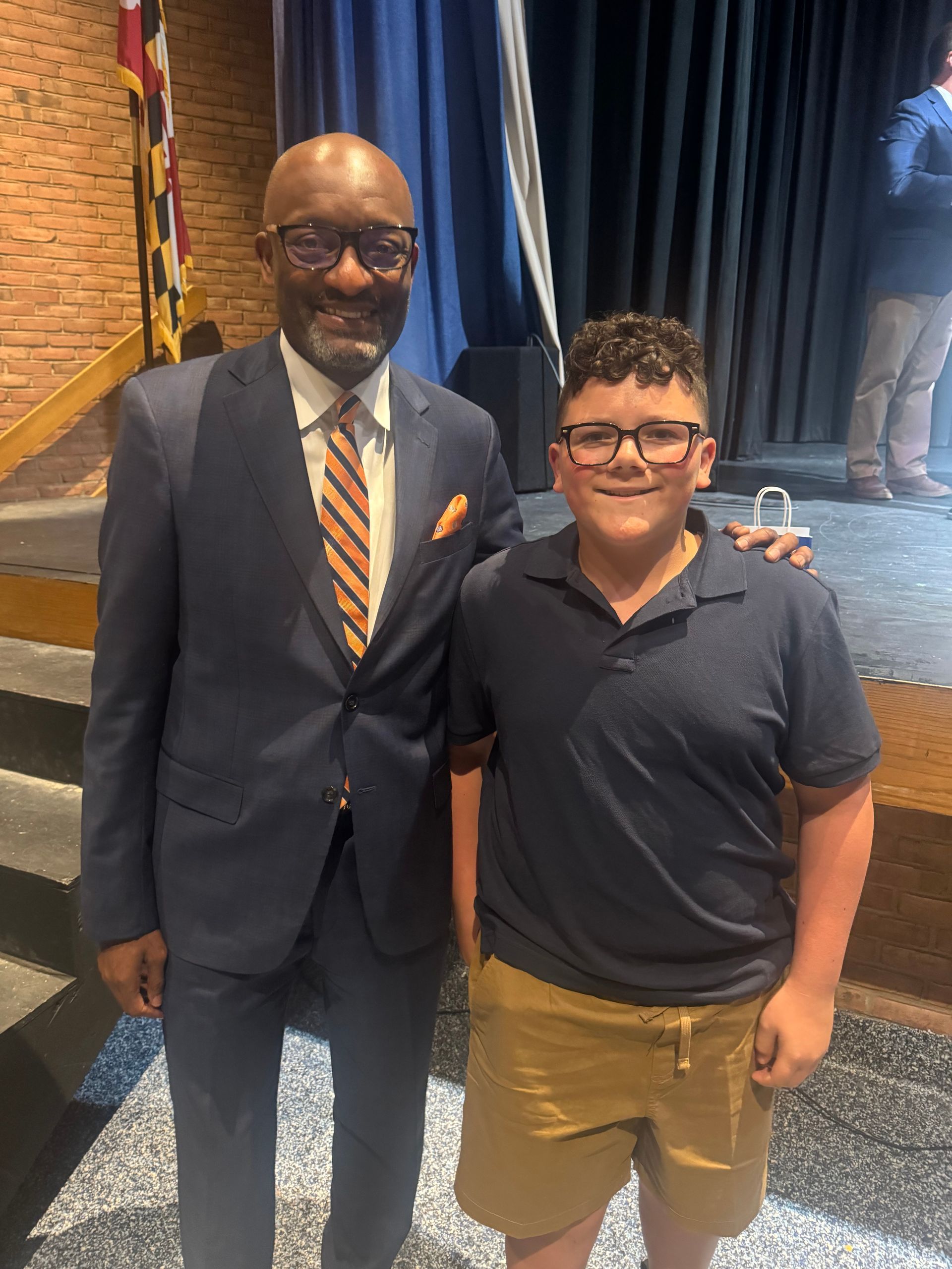 Kid Kindness Spotlight - Mason with a man in a suit
