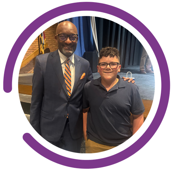 Kindness Grows Here - Mason Willoughby purple semicircle graphic outside of the image 