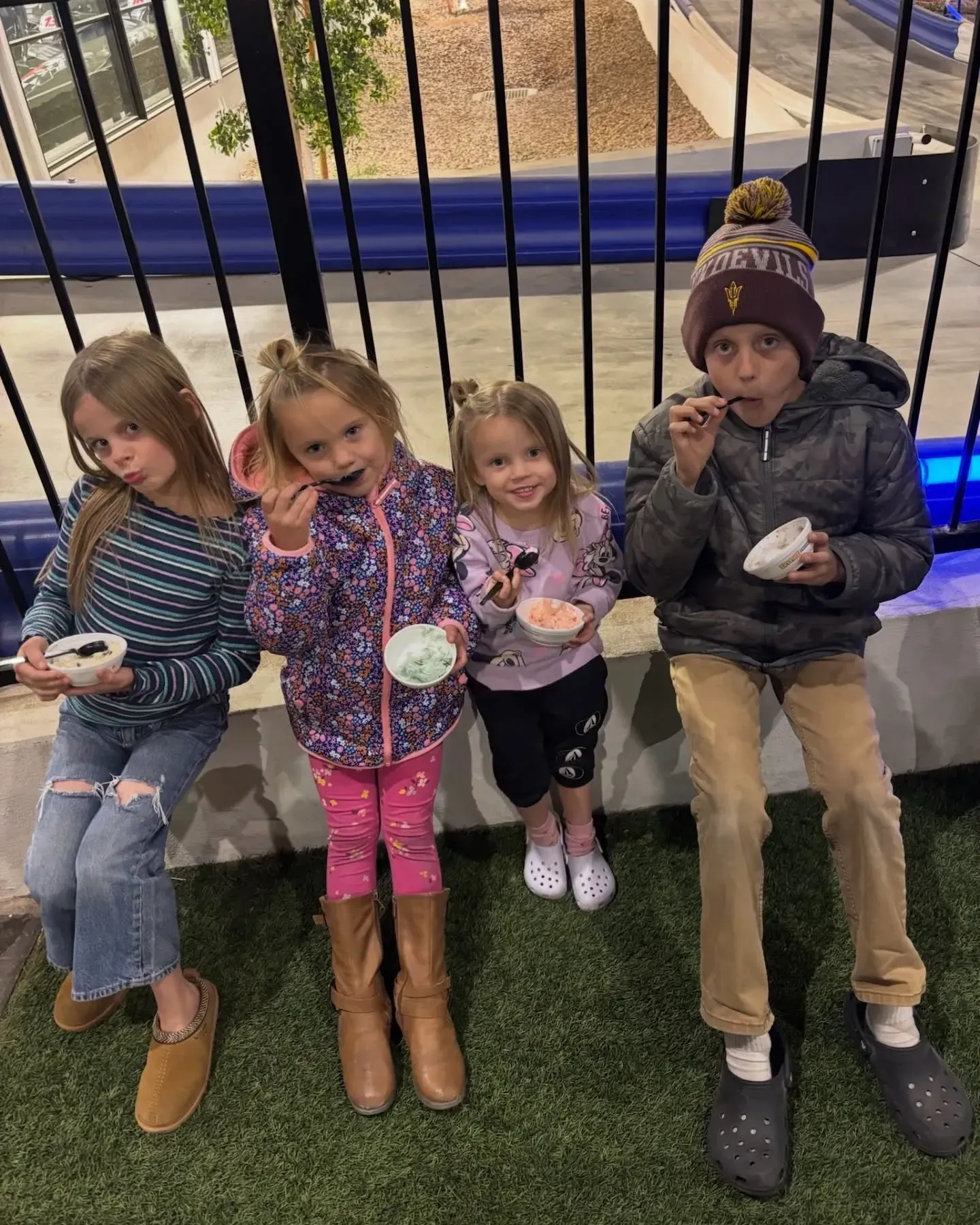 Kids eating ice cream beside the go-kart track at a family fun spot near Gilbert, AZ