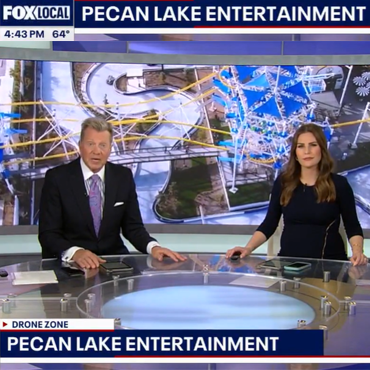 Fox Local news anchors at desk with drone footage of Pecan Lake Entertainment behind them