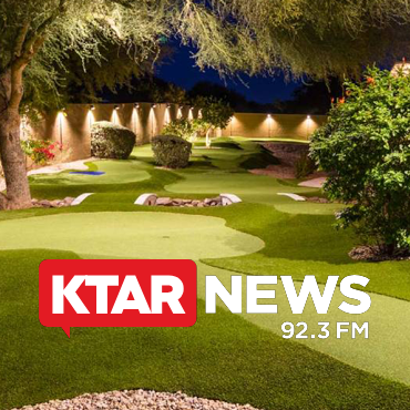 KTAR News 92.3 FM logo over a lit night golf course with putting greens and sand traps