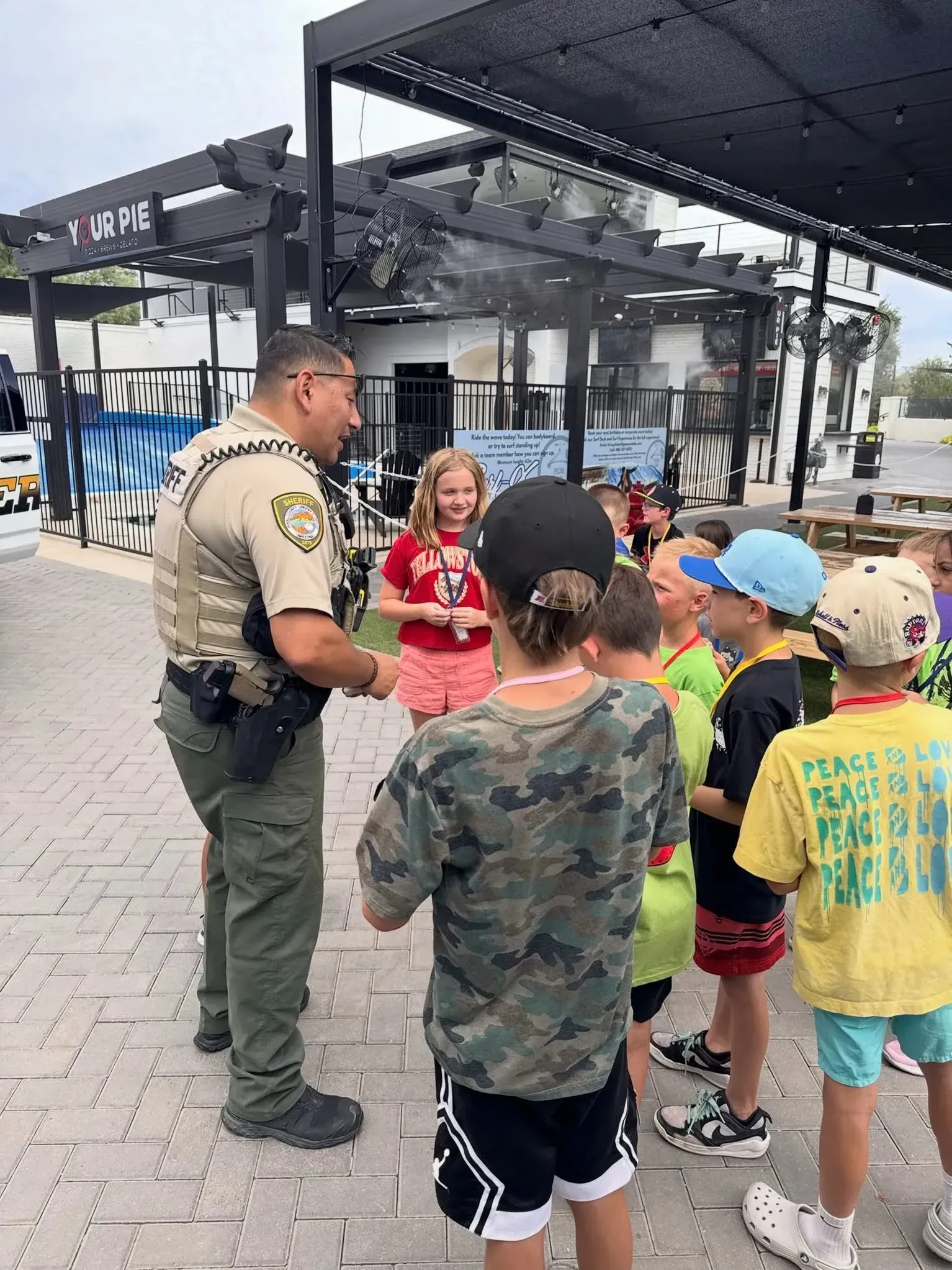 Sheriff’s deputy talking with a group of kids at a school group event at Pecan Lake Entertainment in Queen Creek, AZ Sheriff’s deputy talking with a group of kids at a school group event at Pecan Lake Entertainment in Queen Creek, AZ