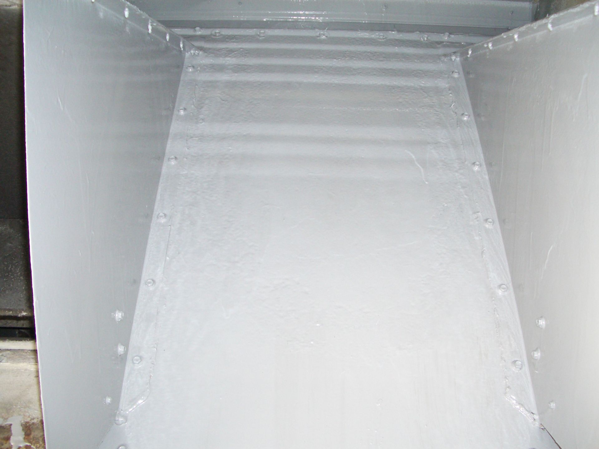 Empty white cardboard box interior with reflective silver lining and folded flaps