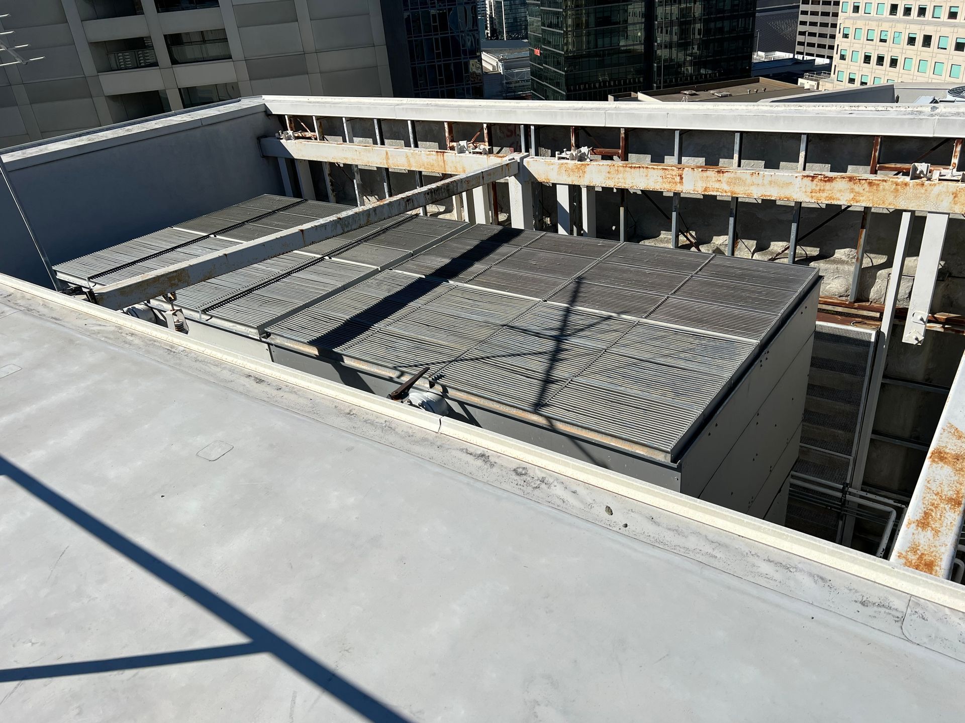 Rooftop construction site with stacked materials and concrete surfaces in a city setting