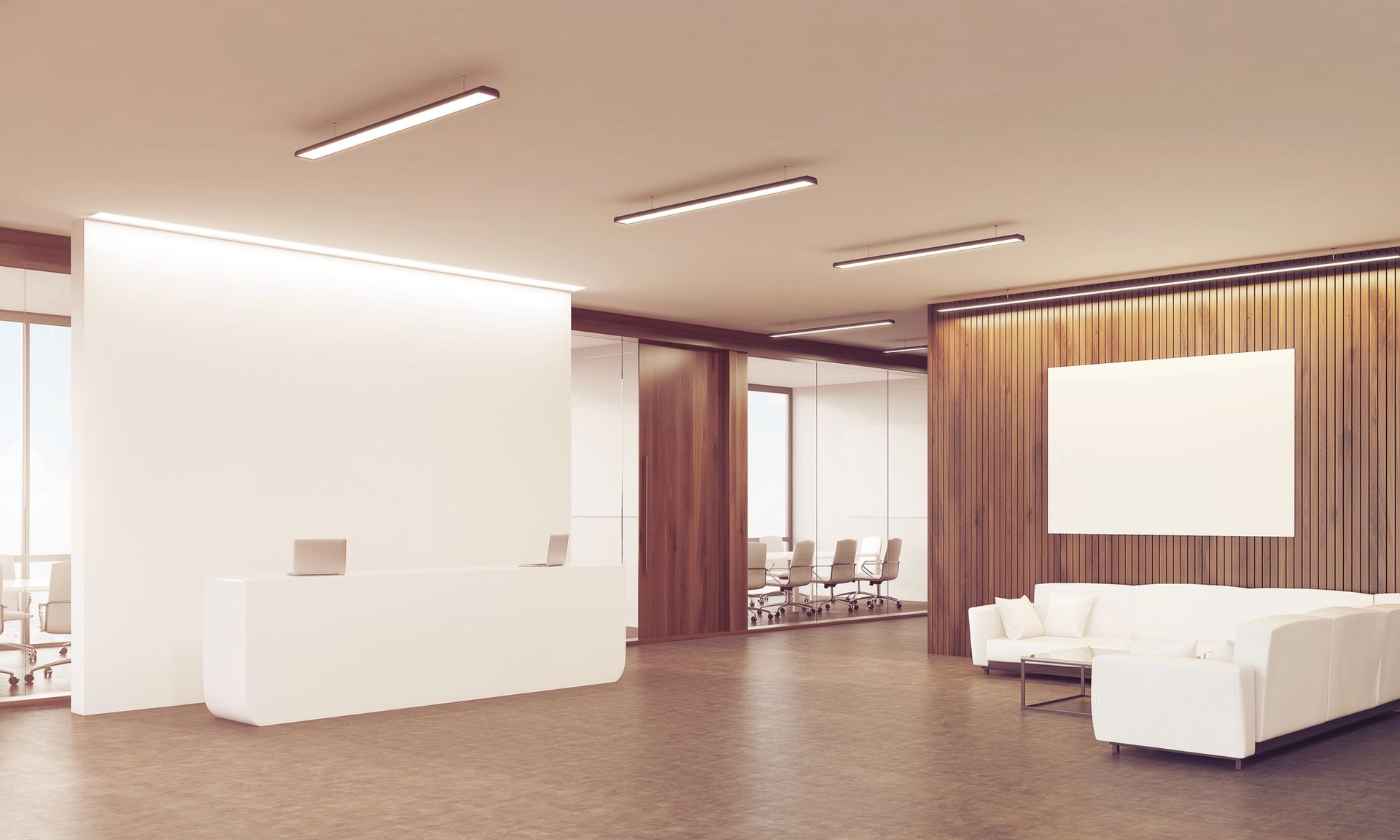 Modern office lobby with a sleek white reception desk, two laptops, and a cozy seating area with white sofas.