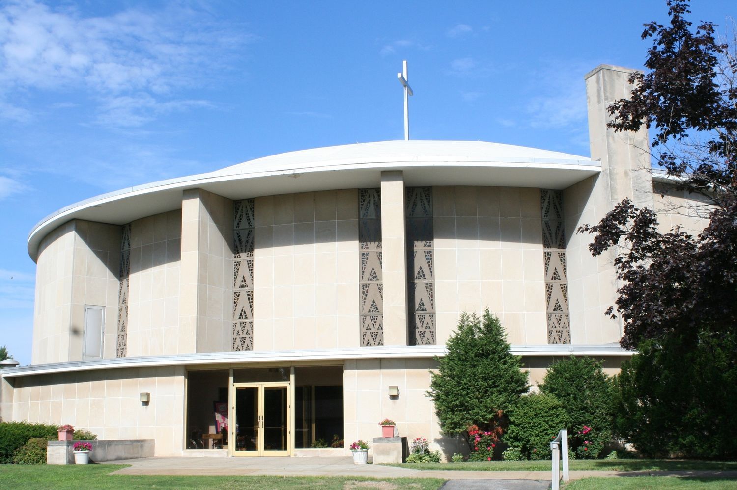 A large church with a cross on top of it
