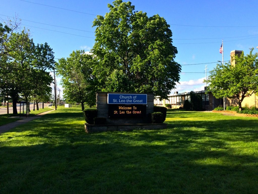 A sign in a grassy field that says ' p.t.v. ' on it