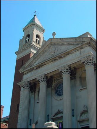 A church with a bell tower and a cross on top