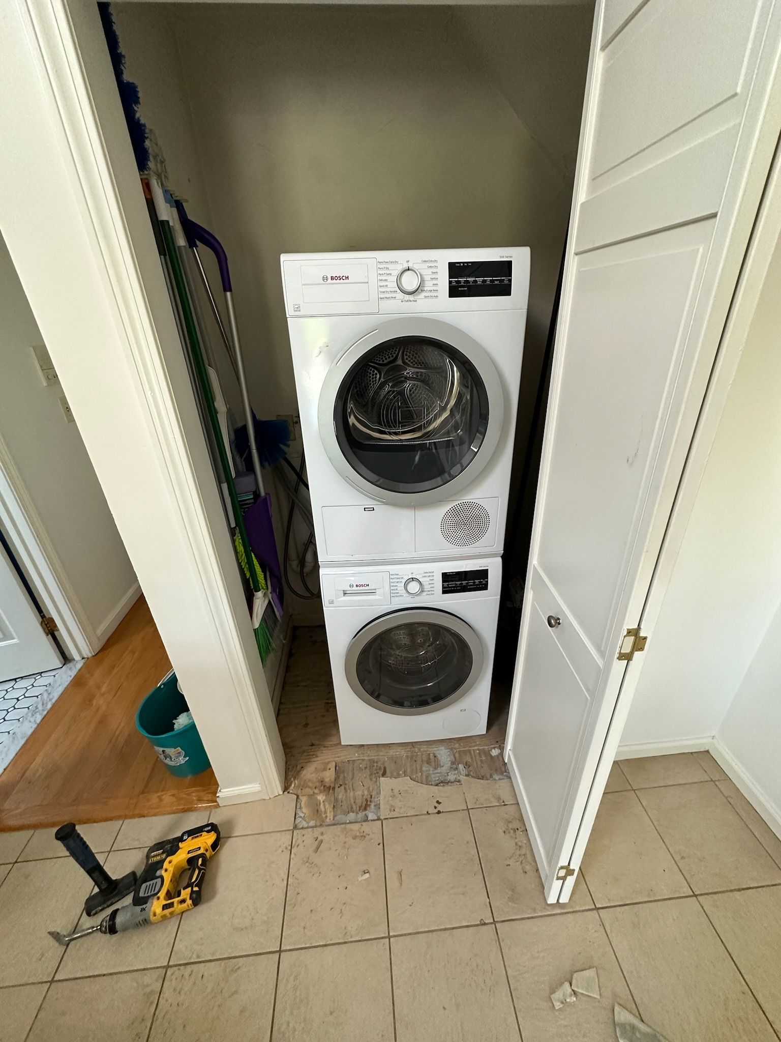 Workers removing large refrigerator through kitchen doorway