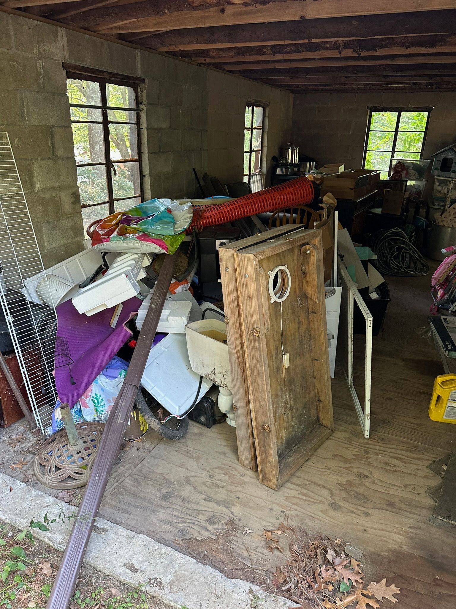 Garage mid-cleanout with items sorted on floor