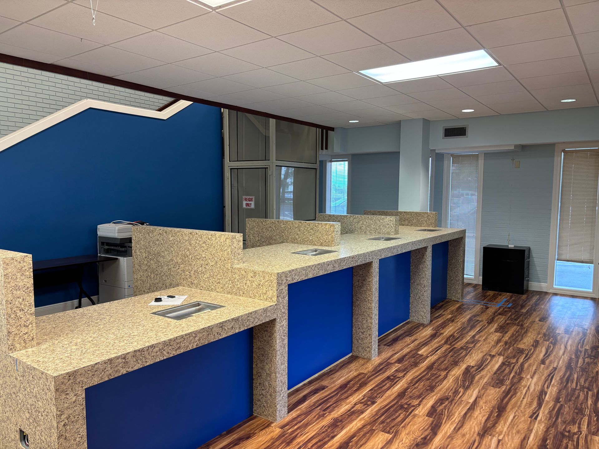 A room with a lot of counters and a printer in it.