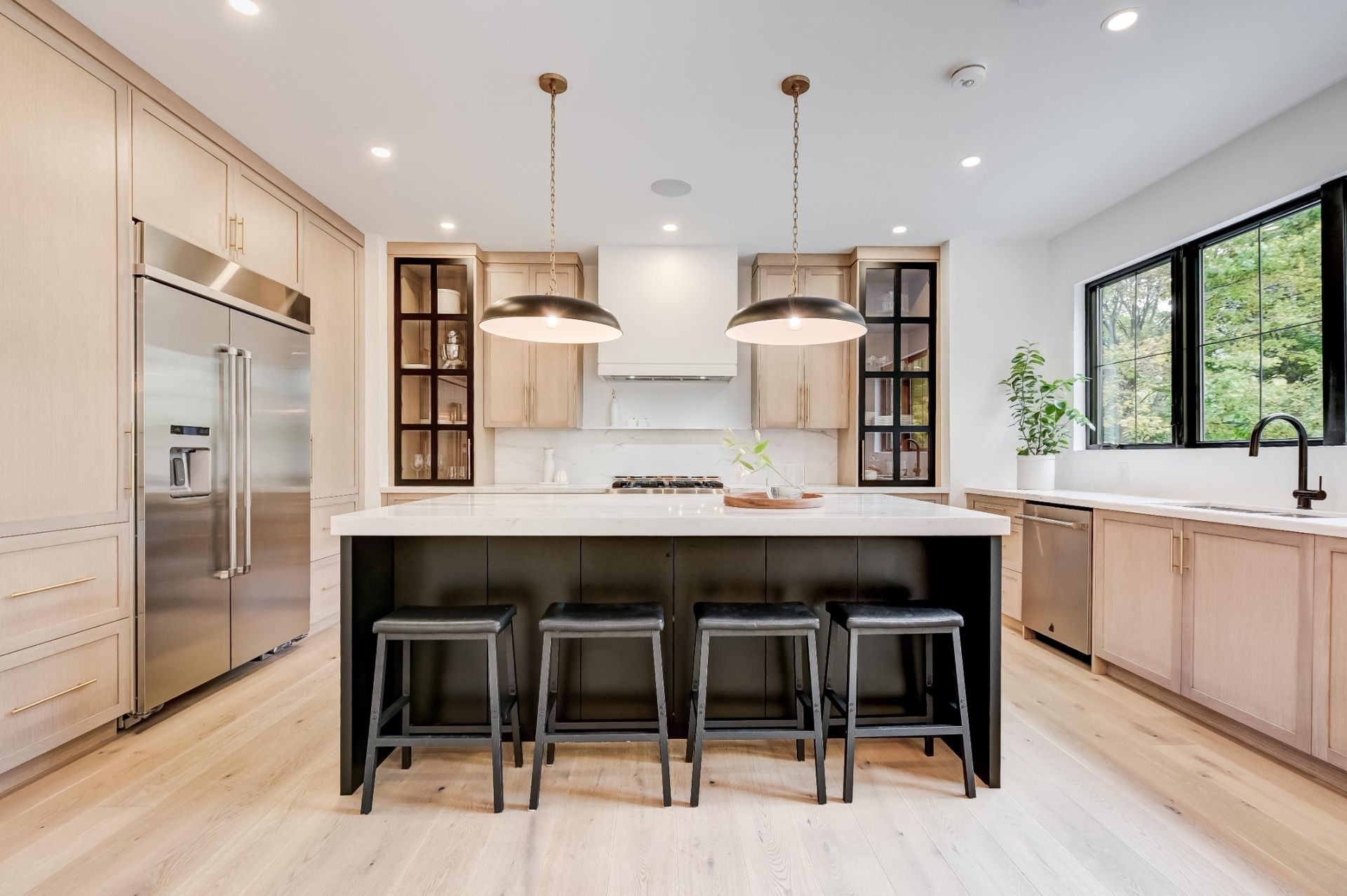A kitchen with a large island and stools.