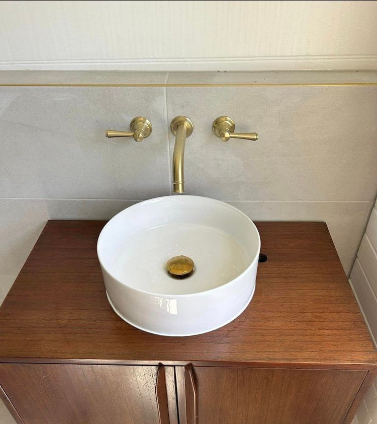 A Bathroom Sink Is Sitting On Top Of A Wooden Cabinet — DMK Plumbing in Crescent Head, NSW