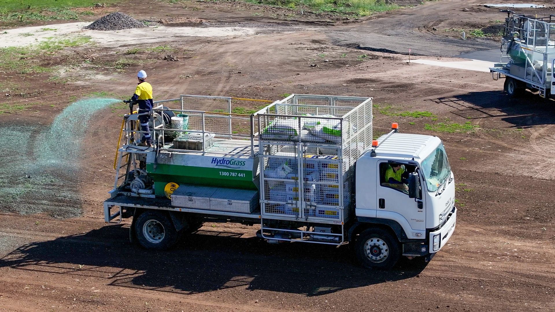 A white truck with a green tank on the back of it
