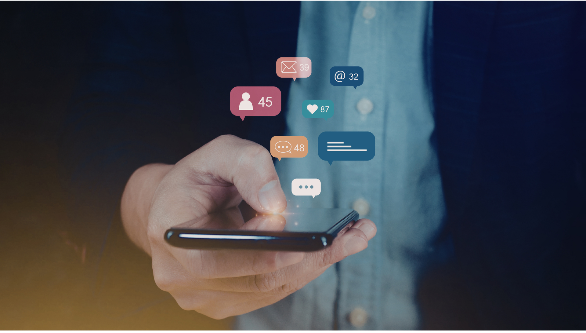Hand holding smartphone with floating social media notification icons on a blurred background