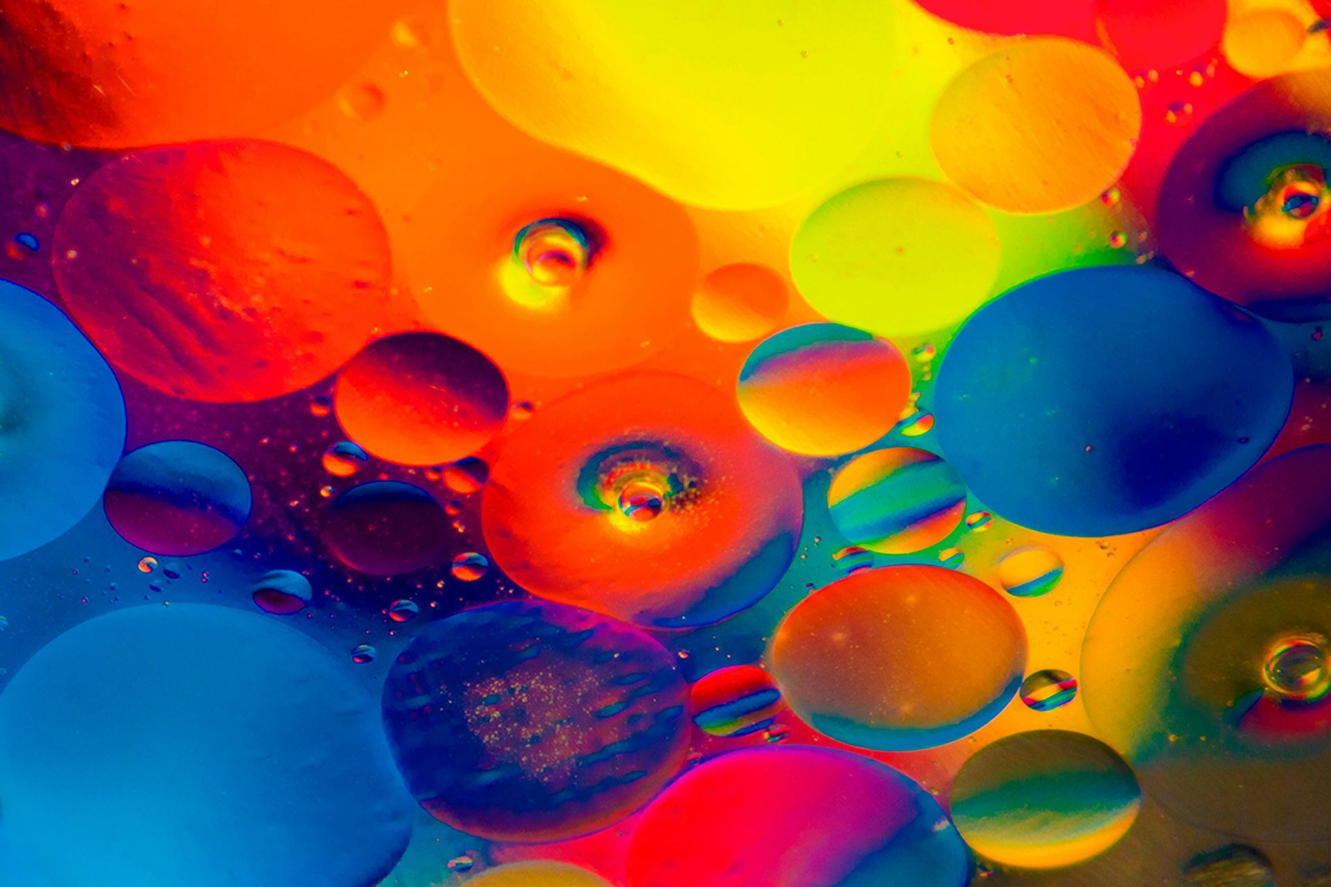 A bunch of colourful bubbles are floating in the water.