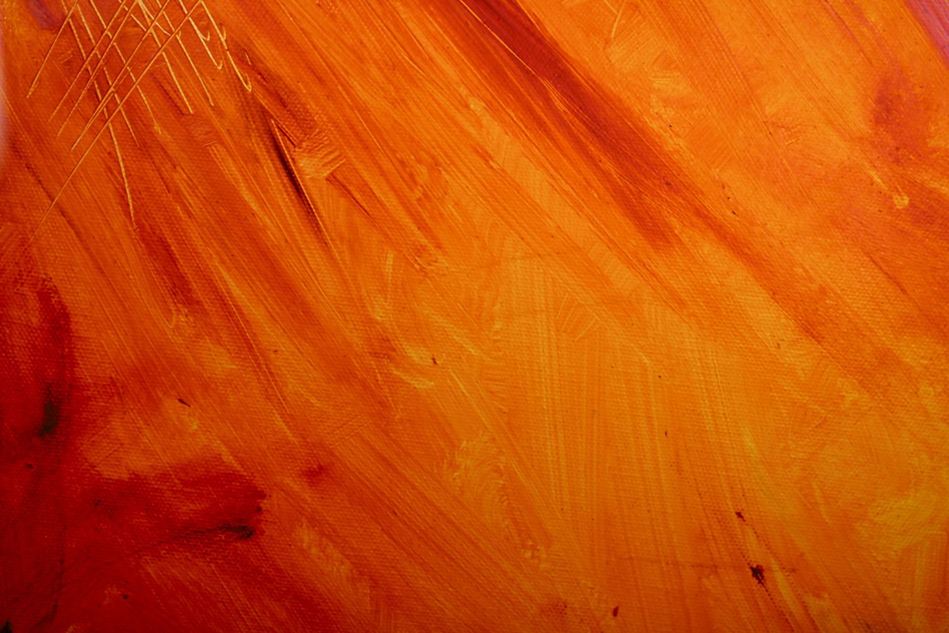 A close up of a red and orange painting on a wall.