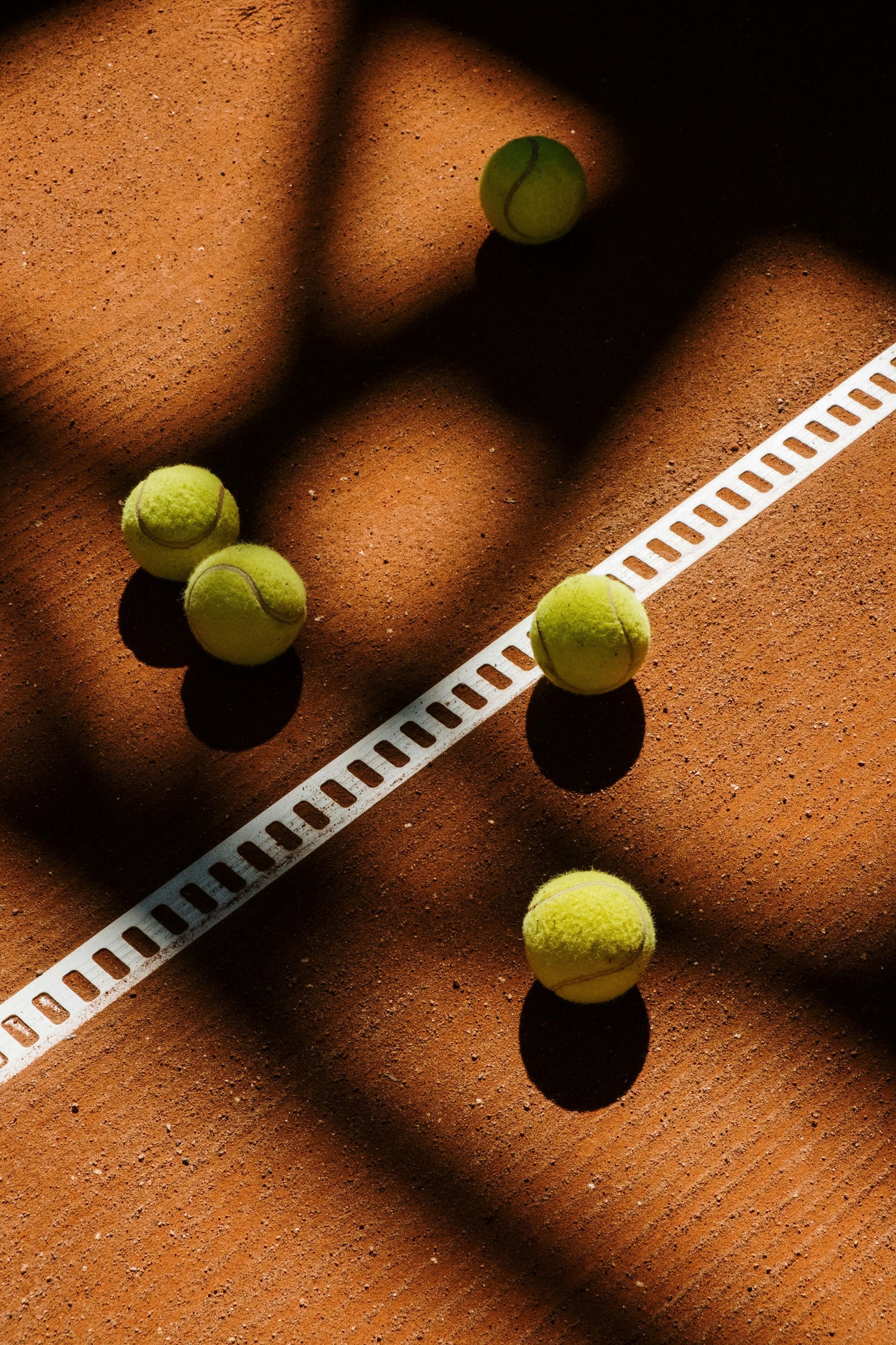 Three tennis balls are sitting on top of a tennis court aligns denoting how we can serve up websites that make sense.