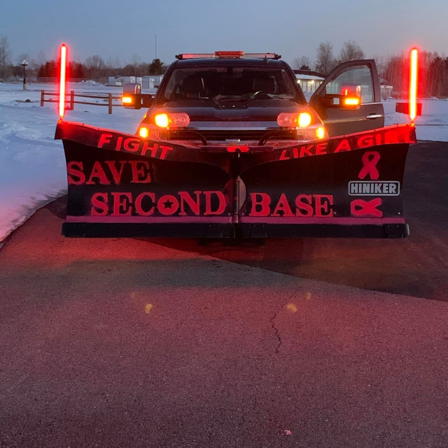 A snow plow that says fight like a girl save second base