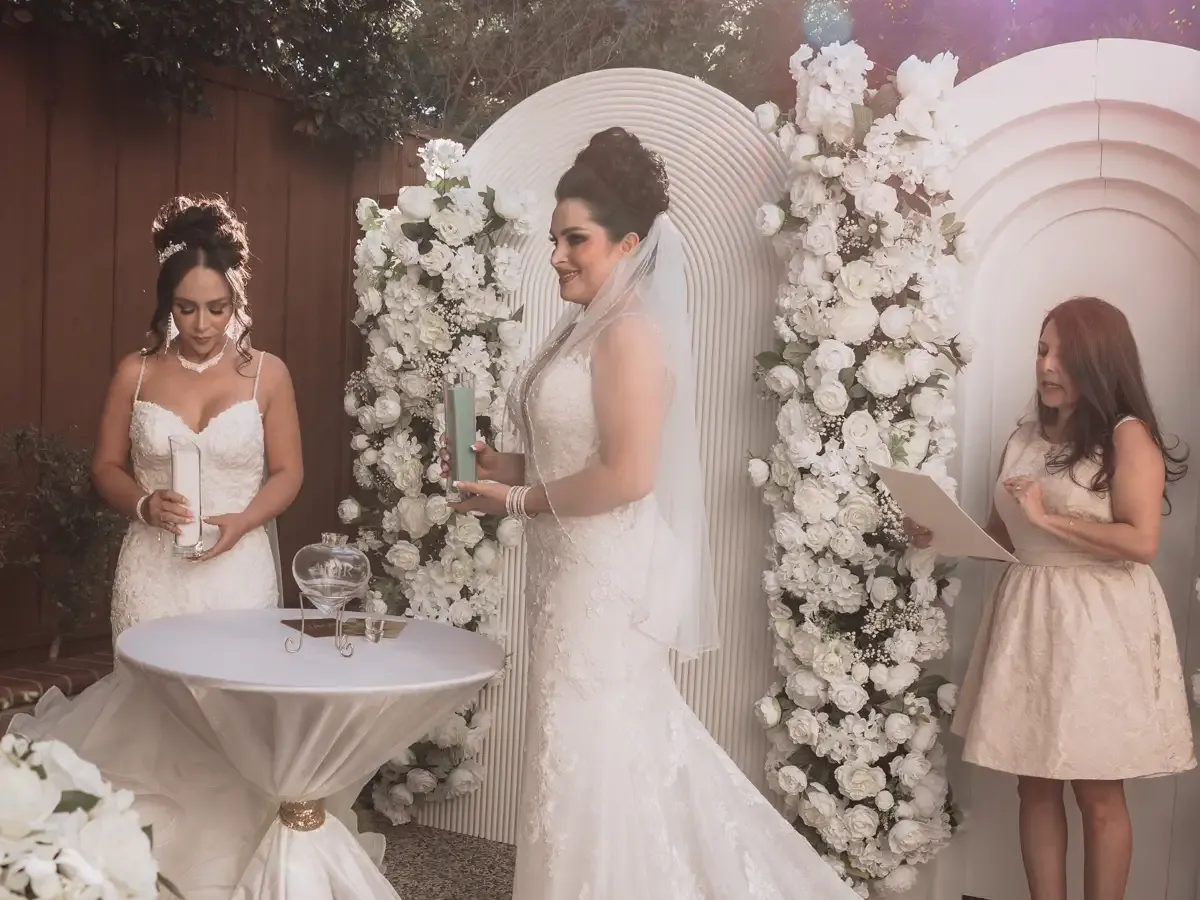 Wedding ceremony with brides pouring sand, floral arch. LGBTQ+ wedding Officiant, Bodas by Lian, Santa Clara, CA.