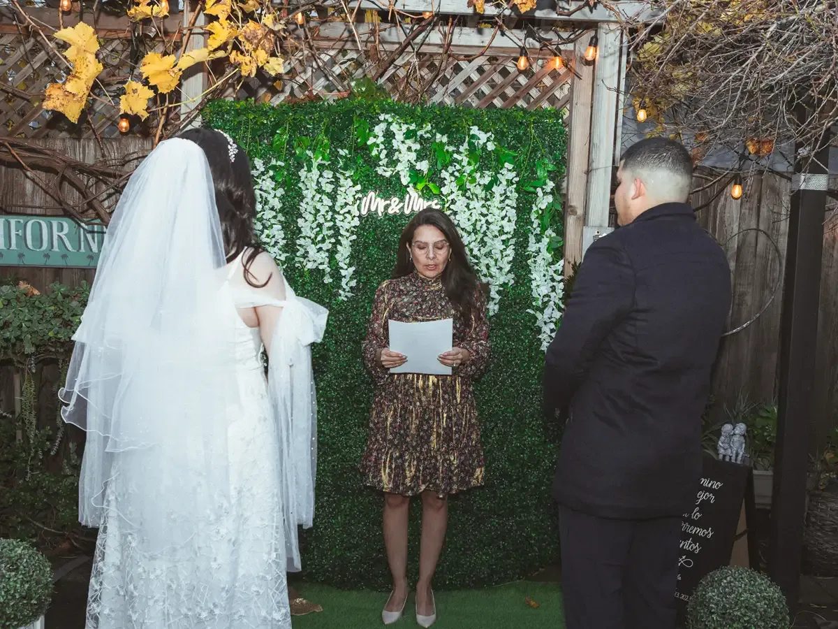 Wedding ceremony; bride in veil, groom, officiant. Bodas by Lina, Santa Clara, CA>