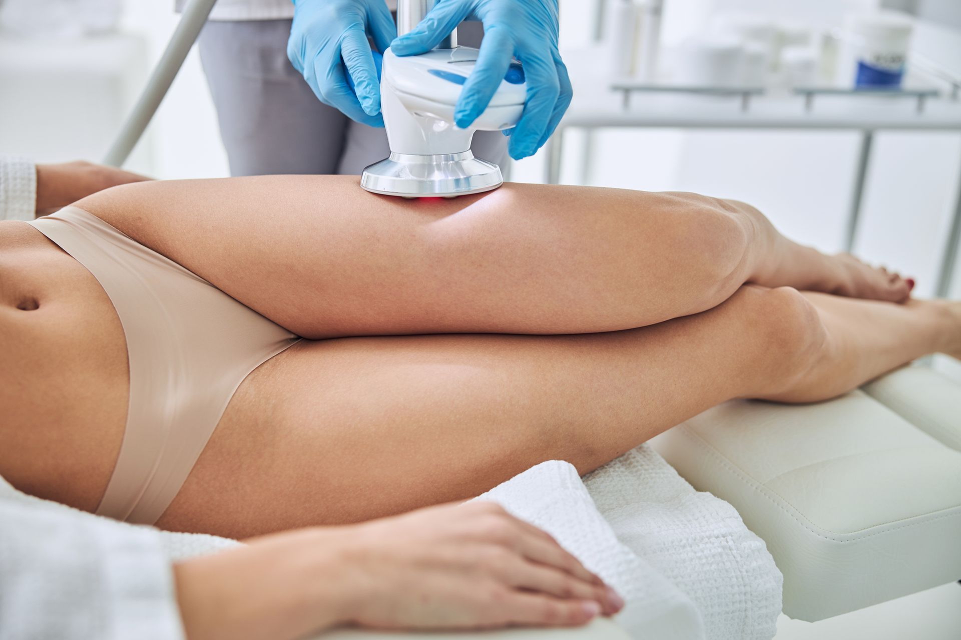 A body sculpting treatment being applied to a woman's abdomen.