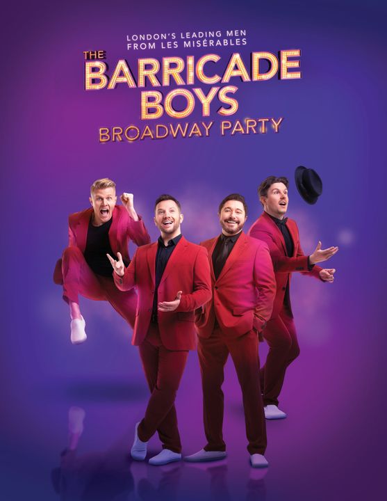 Four gentlemen wearing red suits smile together with the words
