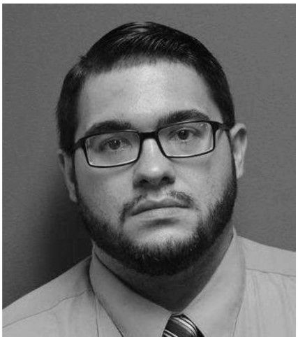 Man with glasses and beard looking at the camera.