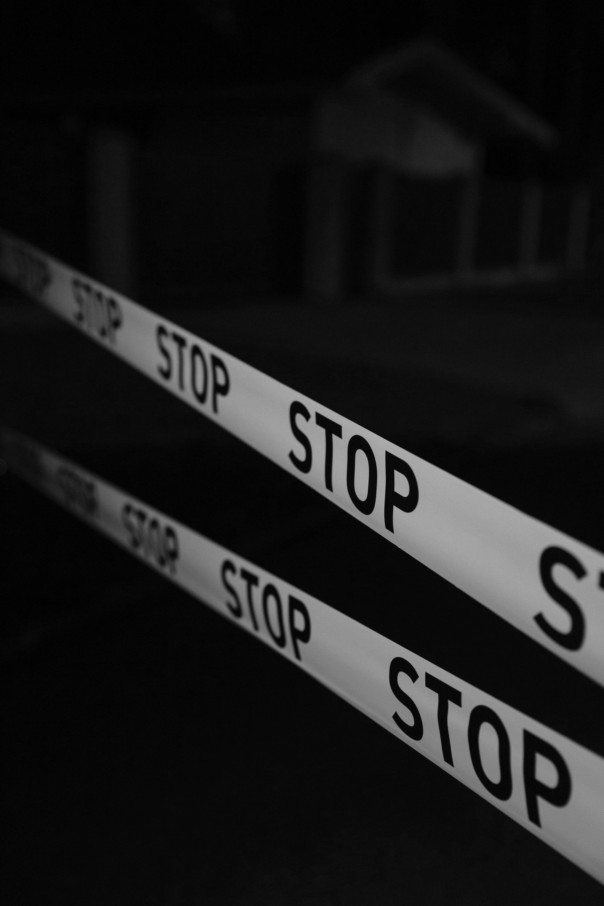 Black and white close-up of caution tape with