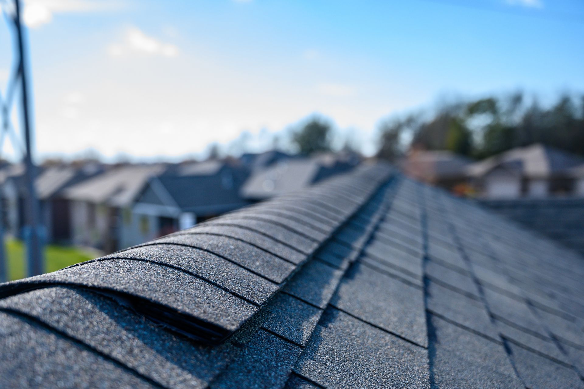 Roofing contractor inspecting flashing detail on a residential roof in Granger, Iowa.